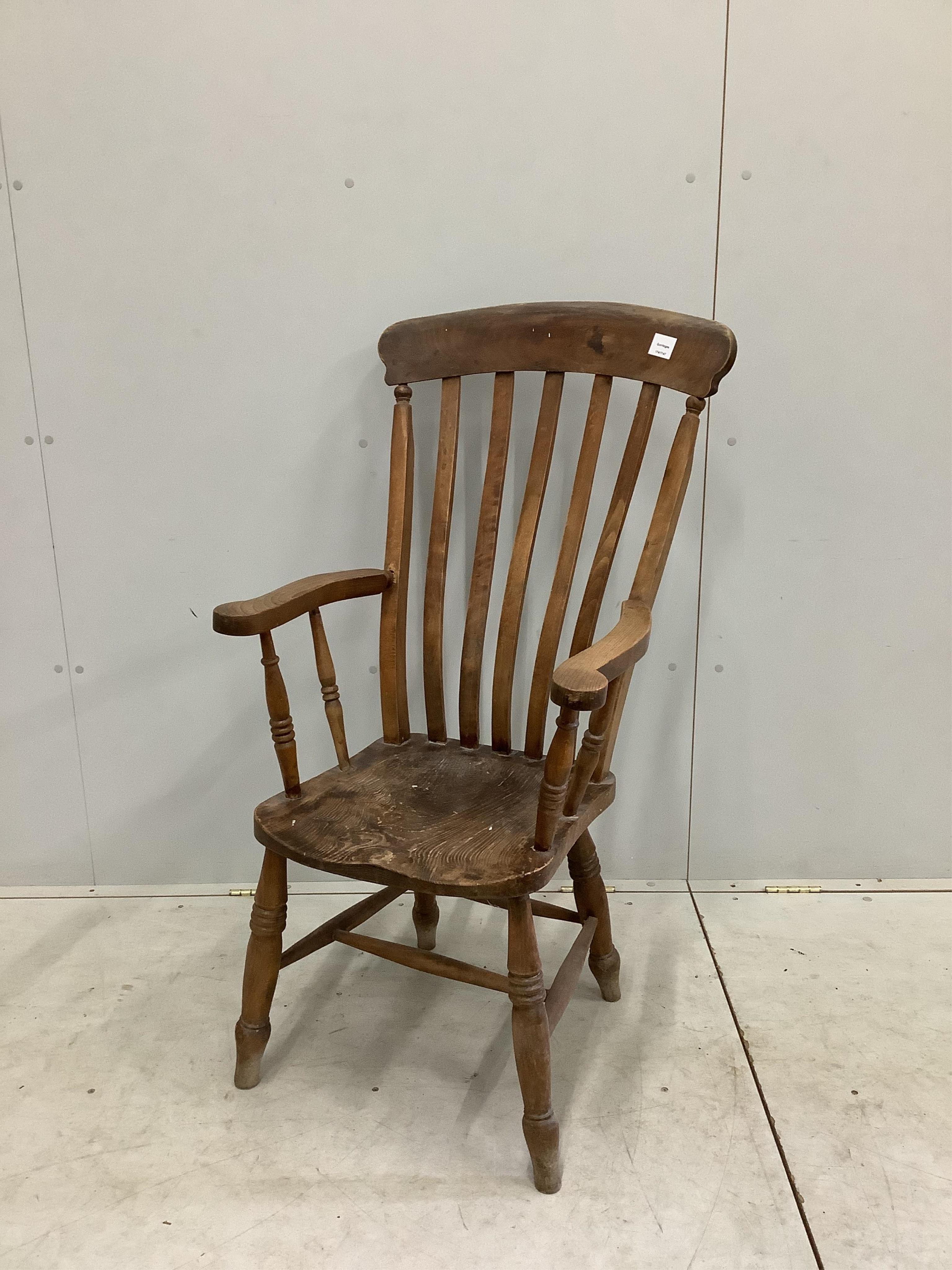 A Victorian elm and beech Windsor lathe back armchair, width 57cm, depth 46cm, height 112cm. Condition - poor